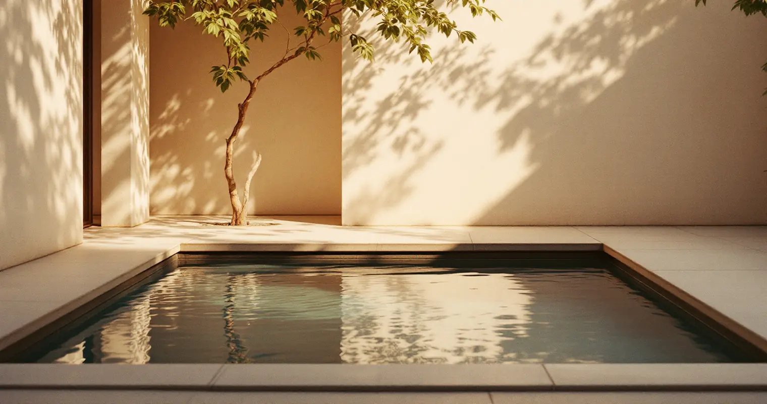 Still water in a small courtyard pool at dawn